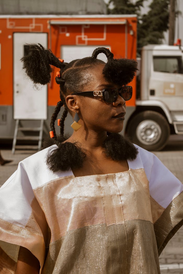 Fashionable woman with distinctive afro hairstyle and sunglasses in Lagos, Nigeria.