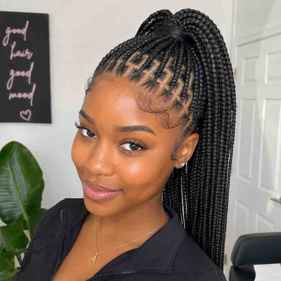 Young Black woman with knotless box braids styled in a high ponytail showing scalp health
