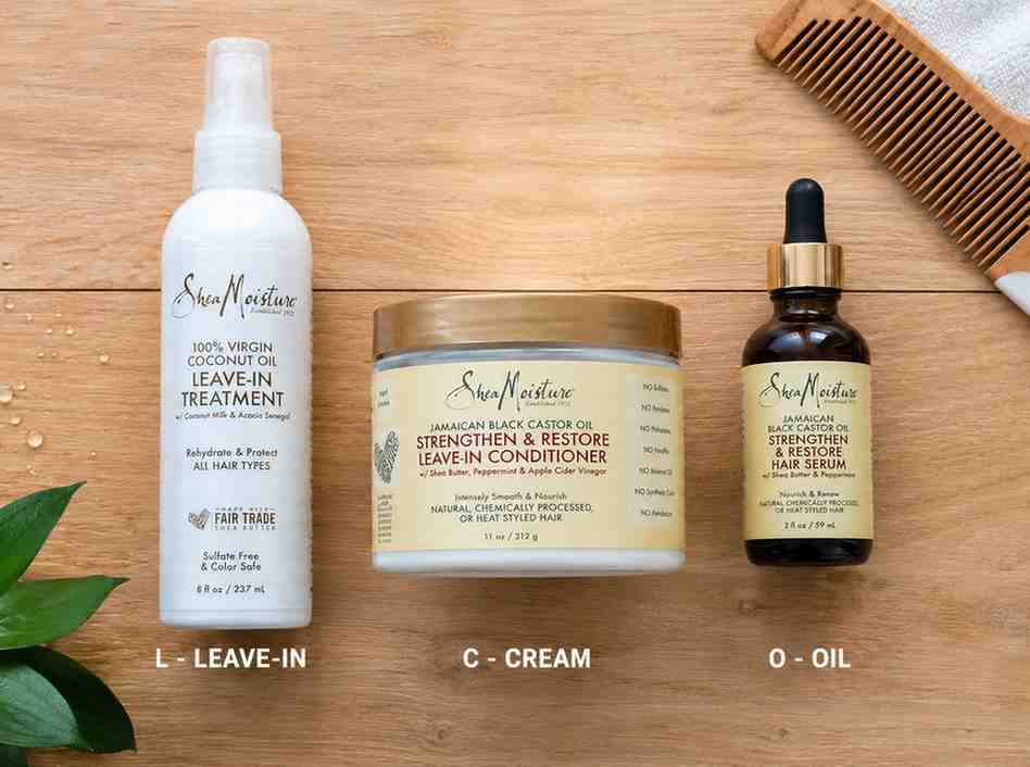 flat lay of leave-in conditioner, moisturizing cream, and sealing oil arranged in LCO method order on wooden surface