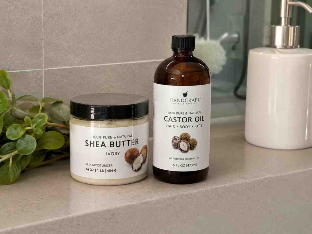 jar of shea butter and bottle of castor oil on a bathroom shelf, representing occlusive sealing products for high porosity hair